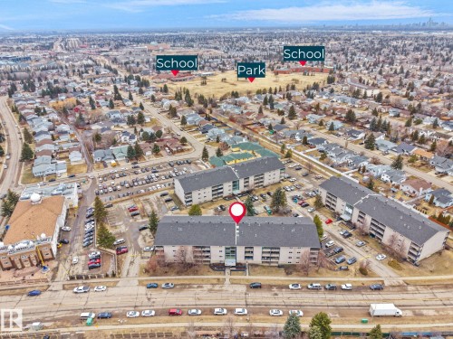 Aerial view of the community, featuring residential buildings, a park, and schools - 214 2620 Mill Woods Road E, Edmonton, AB - Outdoor With View