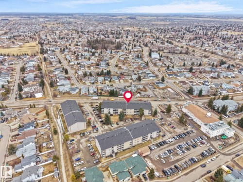 Aerial view of the neighborhood showing a residential area with various buildings and streets - 214 2620 Mill Woods Road E, Edmonton, AB - Outdoor With View