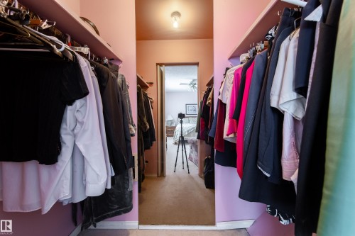 Walk-in closet featuring extensive hanging space on both sides and carpeted flooring - 11 Granada Place, St. Albert, AB - Indoor With Storage