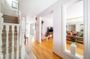 The entry hall features hardwood flooring and a carpeted staircase with white balusters - 11 Granada Place, St. Albert, AB  - Indoor Photo Showing Other Room 