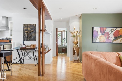 The property features light hardwood floors and recessed lighting throughout - 11026 110 Avenue, Edmonton, AB - Indoor