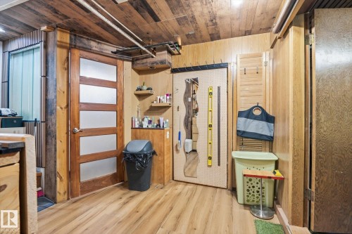This area features wood paneling on the walls and ceiling, creating a warm aesthetic - 11026 110 Avenue, Edmonton, AB - Indoor Photo Showing Basement