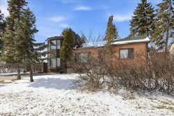 The property features a brick exterior and a rounded bay window - 