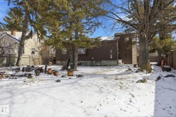 The property features a spacious backyard with mature trees and a fenced perimeter - 