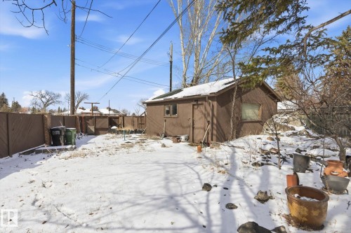 The property features a detached structure with a brown exterior and a fenced yard - 11026 110 Avenue, Edmonton, AB - Outdoor