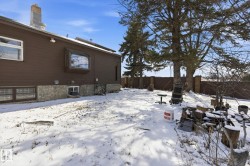 The property features a brown exterior with a stone foundation and a bay window - 