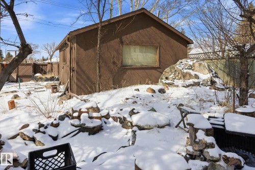 The property includes an exterior storage building with a stucco finish and a window - 11026 110 Avenue, Edmonton, AB - Outdoor