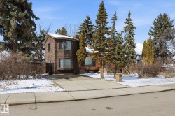 The property features a brown exterior with multiple windows and a curved architectural element - 