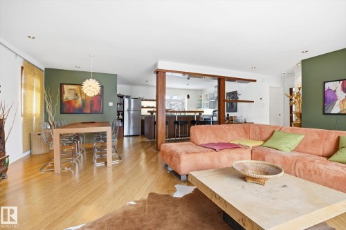 The property features hardwood flooring throughout the main living areas - 11026 110 Avenue, Edmonton, AB - Indoor Photo Showing Living Room