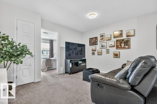 This property features light gray carpeting throughout, white walls, and a recessed ceiling light fixture - 3708 42 Avenue, Beaumont, AB - Indoor