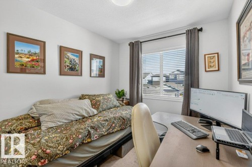 This room features a window with horizontal blinds and draperies, providing natural light - 3708 42 Avenue, Beaumont, AB - Indoor Photo Showing Other Room