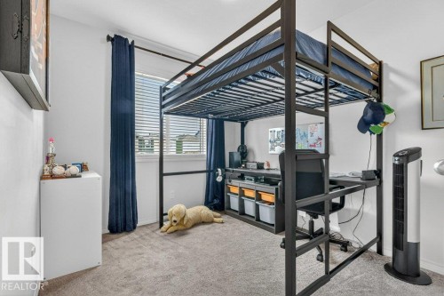 This room features a window with blinds and dark blue curtains, providing natural light - 3708 42 Avenue, Beaumont, AB - Indoor