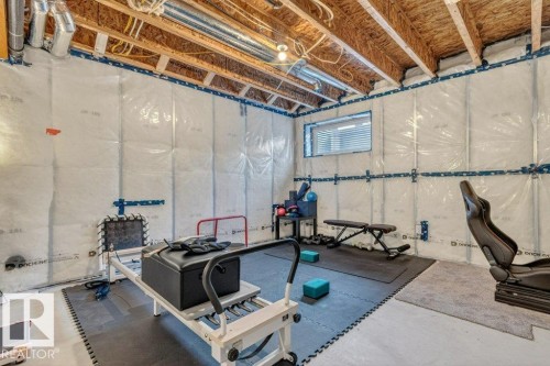 The unfinished basement features exposed wooden ceiling beams and insulation on the walls - 3708 42 Avenue, Beaumont, AB - Indoor Photo Showing Basement
