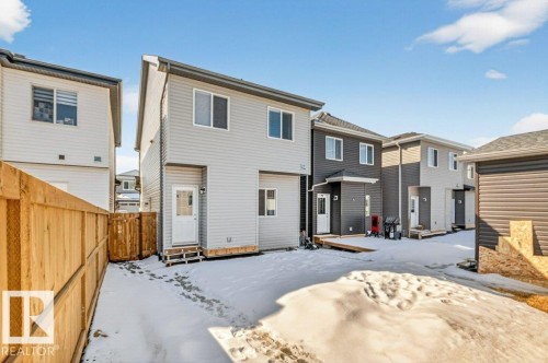 The property features a two-story exterior with light-colored siding and a contrasting roof - 3708 42 Avenue, Beaumont, AB - Outdoor