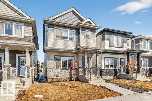 The property features a two-story exterior with siding and stone accents - 3708 42 Avenue, Beaumont, AB - Outdoor With Facade