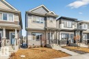 The property features a two-story exterior with siding and stone accents - 3708 42 Avenue, Beaumont, AB  - Outdoor With Facade 