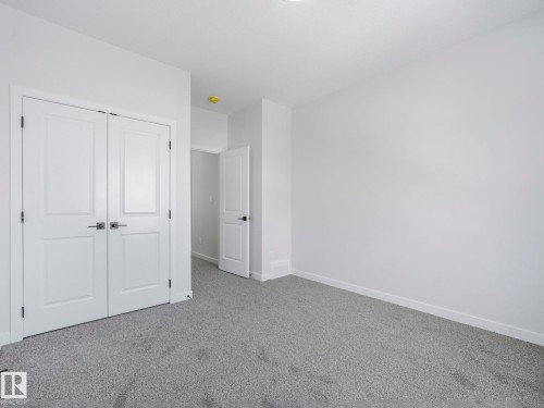 This room features plush grey carpeting, white walls, and bright white trim - 239 Kinglet Boulevard Nw, Edmonton, AB - Indoor Photo Showing Other Room