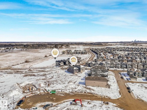 Aerial view of the community, showcasing surrounding properties and distant landscape - 239 Kinglet Boulevard Nw, Edmonton, AB - Outdoor With View