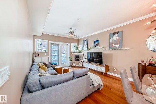 Living area featuring hardwood floors, double patio doors, and a ceiling fan - 307 10121 80 Avenue, Edmonton, AB - Indoor Photo Showing Living Room