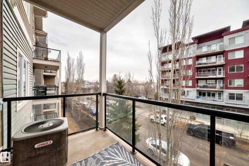 The property features a concrete balcony with glass panel railings - 307 10121 80 Avenue, Edmonton, AB - Outdoor With Balcony With Exterior