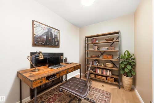 The property features a dedicated space with light-colored walls and light wood flooring - 307 10121 80 Avenue, Edmonton, AB - Indoor Photo Showing Office