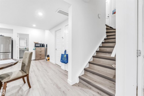Open concept living space featuring light-toned flooring, recessed lighting, and a stainless steel refrigerator - 449 Roberts Crescent, Leduc, AB - Indoor