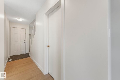 Hall with light wood-style floors and baseboards - 5833 Riverbend Road, Edmonton, AB - Indoor Photo Showing Other Room