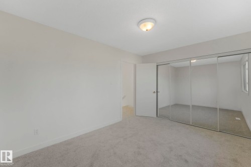 Unfurnished bedroom with carpet floors and a closet - 5833 Riverbend Road, Edmonton, AB - Indoor Photo Showing Other Room