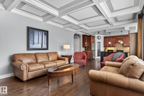 This living space features hardwood floors and a coffered ceiling - 20719 51 Avenue, Edmonton, AB - Indoor Photo Showing Living Room