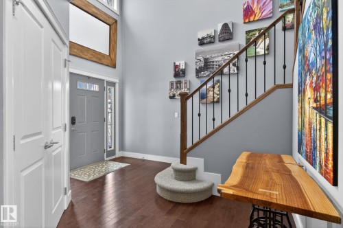 The property features a welcoming entryway with dark hardwood floors and light gray walls - 20719 51 Avenue, Edmonton, AB - Indoor Photo Showing Other Room