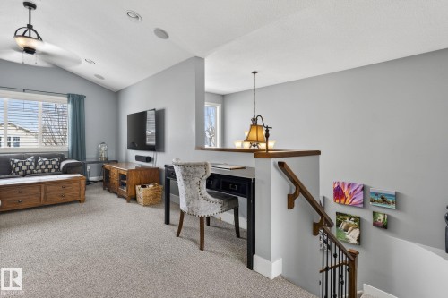 This bright and inviting living space features an angled ceiling with recessed lighting and a ceiling fan - 20719 51 Avenue, Edmonton, AB - Indoor