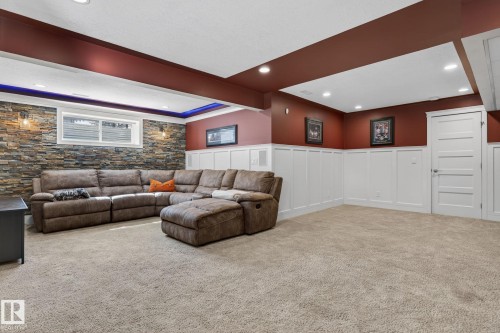 Recreation room featuring an accent wall with stone veneer, recessed lighting, and carpeted flooring - 20719 51 Avenue, Edmonton, AB - Indoor Photo Showing Other Room