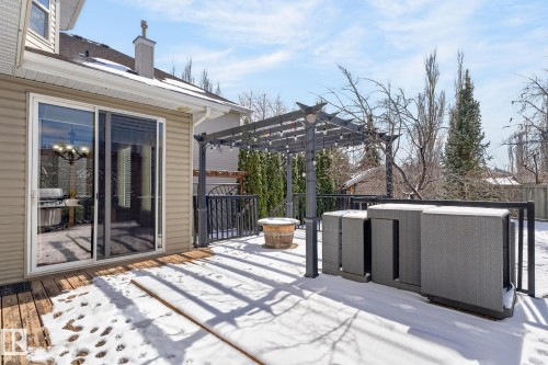 The property features a wood deck with a dark pergola and string lights, offering an inviting outdoor space - 20719 51 Avenue, Edmonton, AB - Outdoor