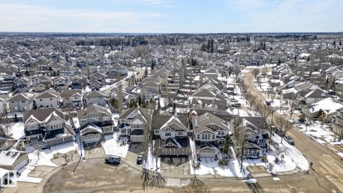 Aerial view showcasing a residential area with varied home styles and visible street infrastructure - 20719 51 Avenue, Edmonton, AB - Outdoor