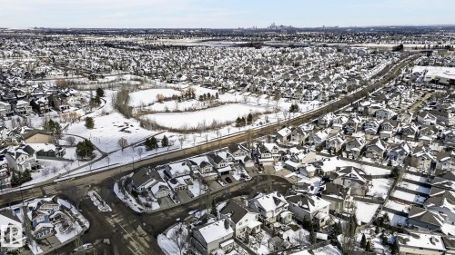 Aerial view of the neighborhood featuring a network of residential streets with homes, and a park area with snow-covered terrain - 20719 51 Avenue, Edmonton, AB - Outdoor With View