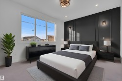 Room featuring a large window, recessed lighting, and a dark accent wall with decorative paneling and sconces - 