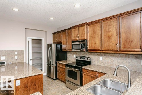 16861 58A Street Nw, Edmonton, AB - Indoor Photo Showing Kitchen With Stainless Steel Kitchen With Double Sink