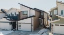 The property showcases a contemporary architectural style with a distinctive sloped roofline, dark brown siding, and white trim - 79 Silverstone Drive, Stony Plain, AB  - Outdoor 