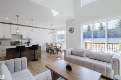 This bright interior features an open-concept layout with light-toned flooring throughout - 