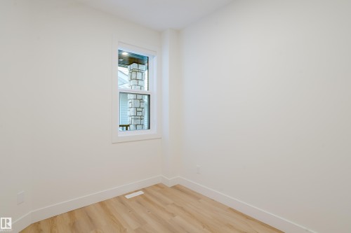 This room features light-colored walls, light wood flooring, and a window with white trim - 79 Silverstone Drive, Stony Plain, AB - Indoor Photo Showing Other Room