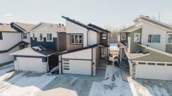 The property features a modern exterior design with mixed siding and stone accents - 