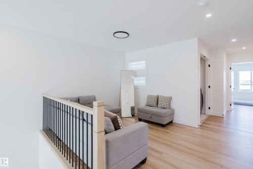 This versatile landing area features light-toned flooring and white walls, offering a bright and inviting atmosphere - 79 Silverstone Drive, Stony Plain, AB - Indoor