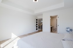 The property features light wood flooring, white walls, and a tray ceiling - 