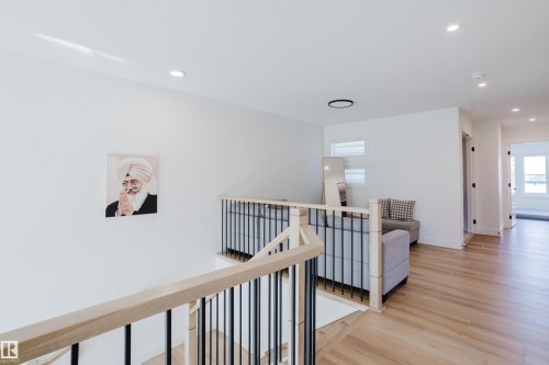 The property features light wood flooring, white walls, and recessed lighting - 79 Silverstone Drive, Stony Plain, AB - Indoor Photo Showing Other Room