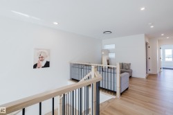 The property features light wood flooring, white walls, and recessed lighting - 
