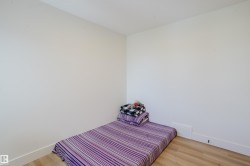 This room features light-colored walls and hardwood-style flooring - 