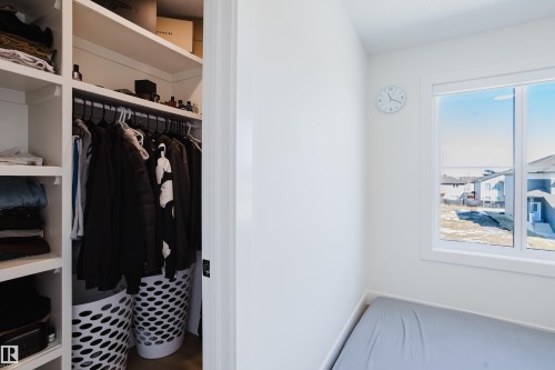 This space features a built-in closet with shelving and hanging rods, providing organized storage - 79 Silverstone Drive, Stony Plain, AB - Indoor