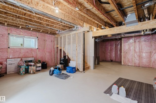 The property features an unfinished basement with exposed wooden joists and insulation - 79 Silverstone Drive, Stony Plain, AB - Indoor Photo Showing Basement