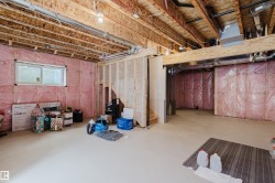 The property features an unfinished basement with exposed wooden joists and insulation - 