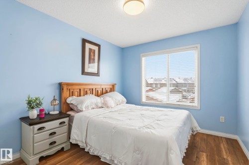 The room features durable hardwood flooring and a ceiling-mounted light fixture, providing illumination - 4783 Crabapplle Run, Edmonton, AB - Indoor Photo Showing Bedroom
